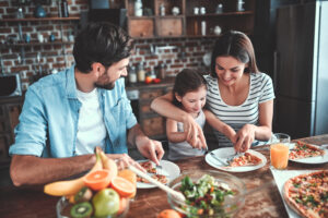 child eats a nutritious meal with variety with parents