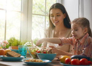 child tries new food and eats a variety of nutritious foods